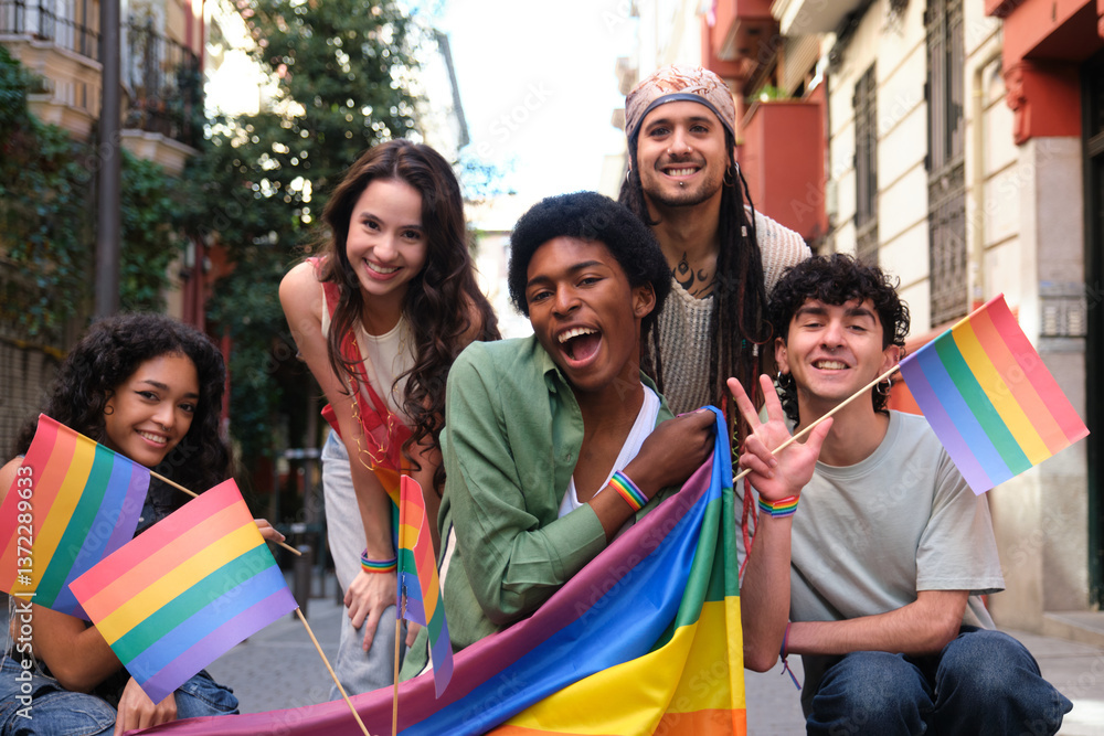 Group of happy multi ethnic friends celebrating gay pride holding rainbow flags