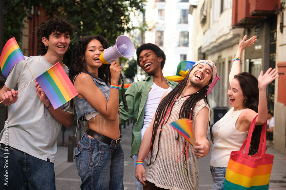 Multi ethnic activists marching for equal rights holding rainbow flags and megaphone