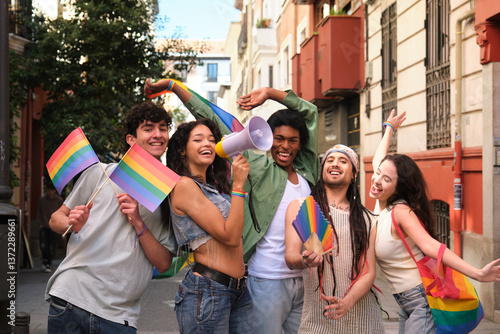 Obraz na płótnie Group of friends having fun at lgbt pride parade, waving rainbow flags and using megaphone w salonie