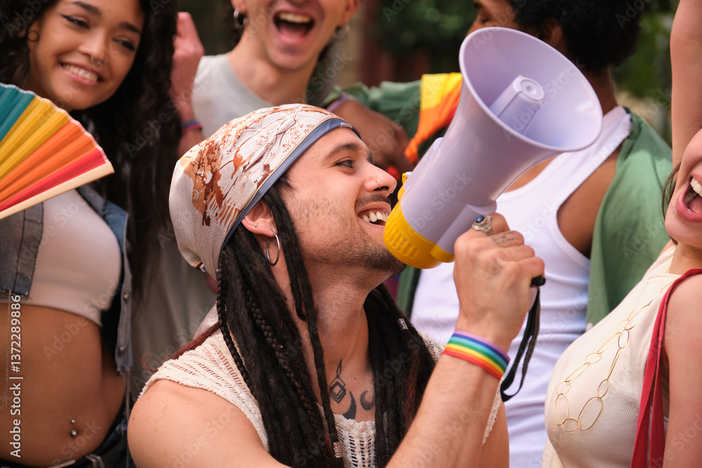 Young man using a megaphone during a LGBT pride parade, promoting equal rights and diversity
