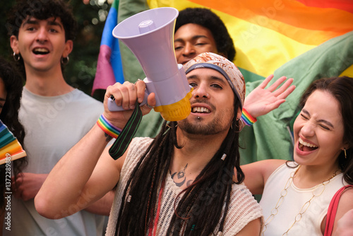 Group of friends celebrating gay pride holding rainbow flag and megaphone, fighting for equal rights