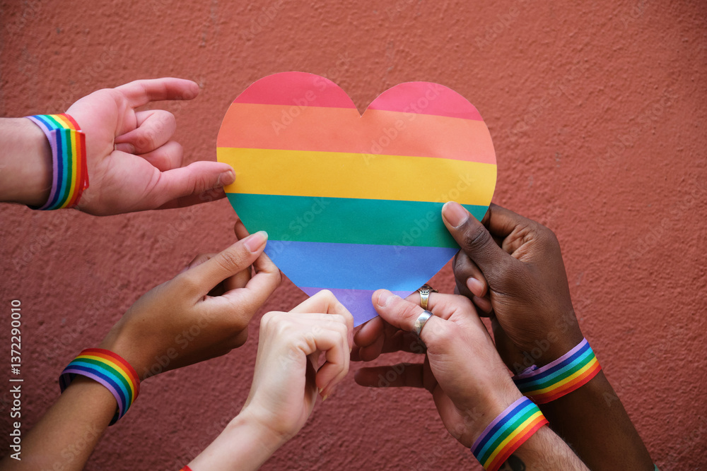 Hands holding a rainbow heart, celebrating LGBT pride and promoting diversity and inclusion