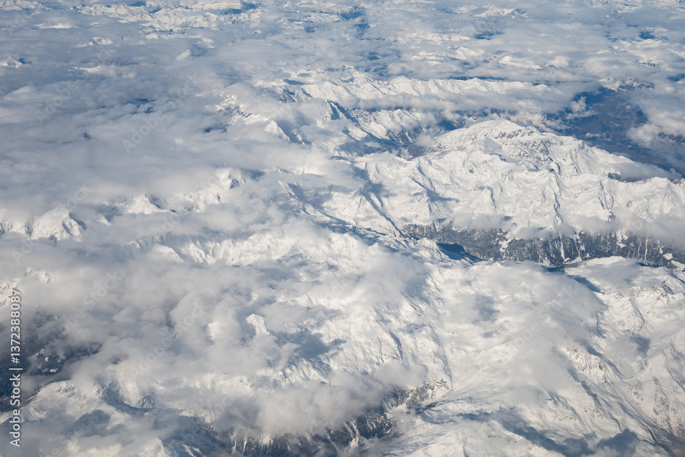 Snowy Alps mountains view from the plane