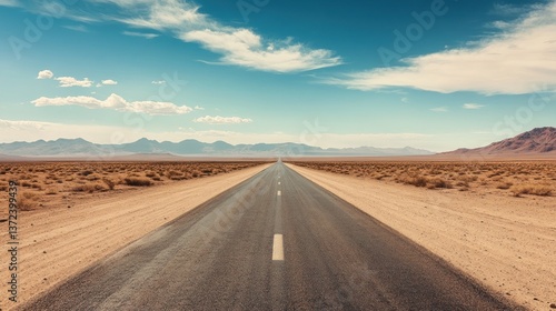 A mesmerizing desert highway stretching towards the distant horizon under a vast sky