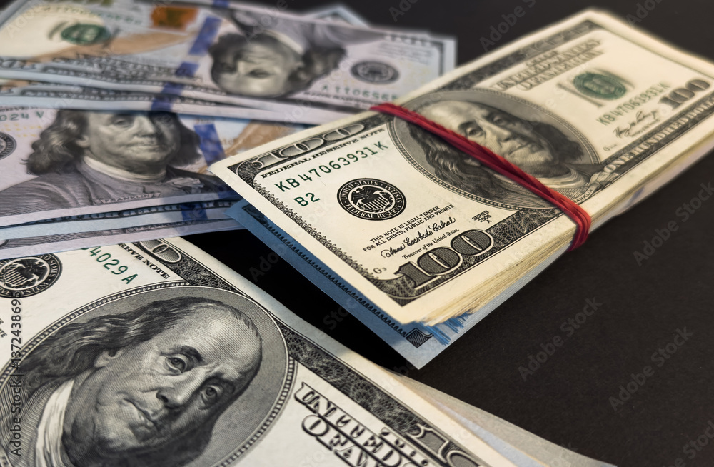 Money, US hundred dollar bills background on white wooden background. Money is scattered on the table. Finance and economics concepts.Money accumulation concept.Currency saving.Investment.Copy space. Money, US hundred dollar bills background on white wooden background. Money is scattered on the table. Finance and economics concepts.Money accumulation concept.Currency saving.Investment.Copy space.