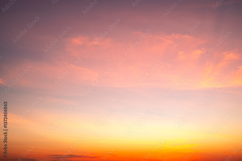 Obraz premium Sky,sunset, beautiful , luxury soft gradient orange gold clouds and sunlight on the blue sky perfect for the background, Sunrise on morning or evening in winter warm time ,Twilight summer,silhouette