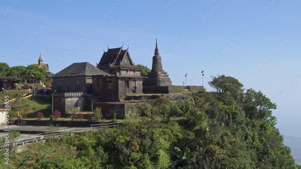 Bokor National Park, building sits atop a hill surrounded by lush trees Bokor National Park, building sits atop a hill surrounded by lush trees