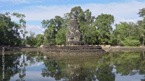 Angkor Wat, A remarkably tall building set against dense jungle backdrop