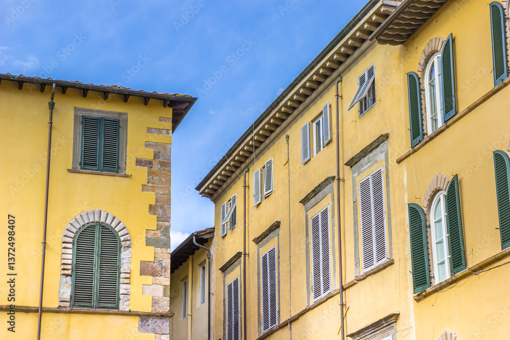 Yellow houses on the San Michele square in Lucca, Italy