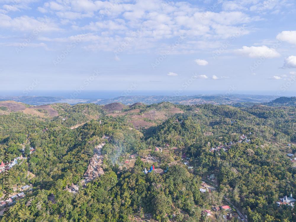 Obraz premium West Sumba, East Nusa Tenggara, Indonesia – 07. 15. 2024 – The traditional villages of Sumba are usually constructed on elevated hills, a prime example is Prai Ijing Village, perched high on a hillsi