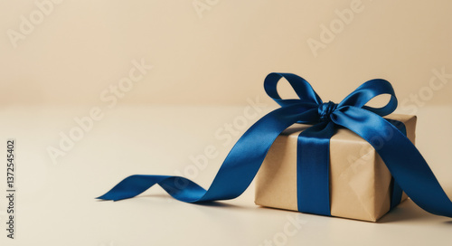 Fototapeta kuchenna Gift box with blue ribbon bow on beige background. Elegant present concept for celebration occasions and gift wrapping inspiration