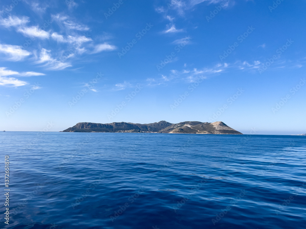 Peaceful View Of Meis Island Across Calm Blue Sea From Kaş, Turkey, On A Sunny Spring Day, Concept Of Tranquility, Freedom, Travel, Tourism, And Natural Beauty. Peaceful View Of Meis Island Across Calm Blue Sea From Kaş, Turkey, On A Sunny Spring Day, Concept Of Tranquility, Freedom, Travel, Tourism, And Natural Beauty.