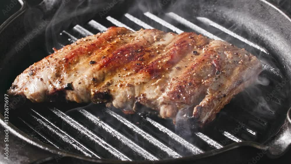cook is frying pork ribs on a hot grill pan cook is frying pork ribs on a hot grill pan