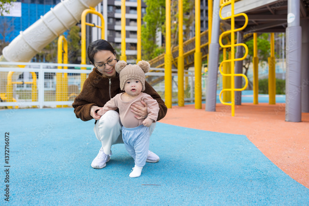 Baby first walking experience with loving mother
