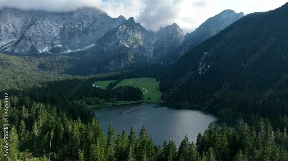 Ascending drone shot of the Alpine Lakes of Fusine (Laghi di Fusine) in Tarvisio, Udine, Italy Ascending drone shot of the Alpine Lakes of Fusine (Laghi di Fusine) in Tarvisio, Udine, Italy