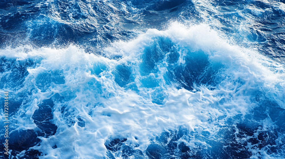 Aerial view of ocean waves crashing with white foam and deep blue water in a natural setting. Aerial view of ocean waves crashing with white foam and deep blue water in a natural setting.