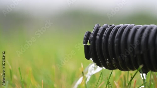 video of a residential sump pump drain line with a trickle discharging of water. 