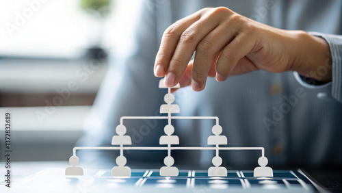 hand is hovering over 3D staff hierarchy tree, symbolizing organizational structure and management