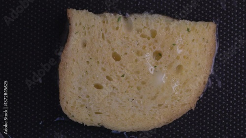 Croutons of bread are fried in a frying pan.