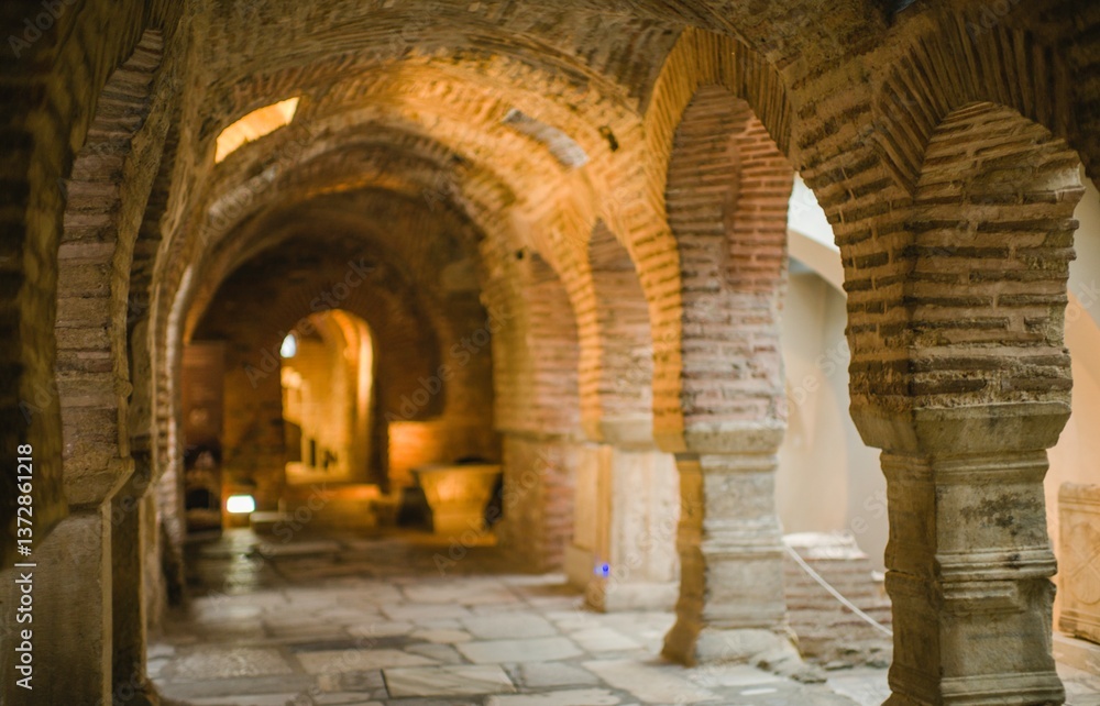 Walking through a serene historical site in Greece reveals stunning arches and smooth stone paths. The warm summer light enhances the beauty of this ancient architecture Walking through a serene historical site in Greece reveals stunning arches and smooth stone paths. The warm summer light enhances the beauty of this ancient architecture