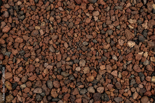 Close-up background texture of picón, lapilli, and reddish volcanic stones