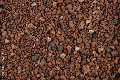 Close-up background texture of picón, lapilli, and reddish volcanic stones