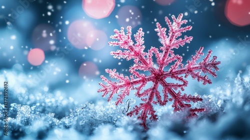 A pink snowflake on a blue background with bokeh lights