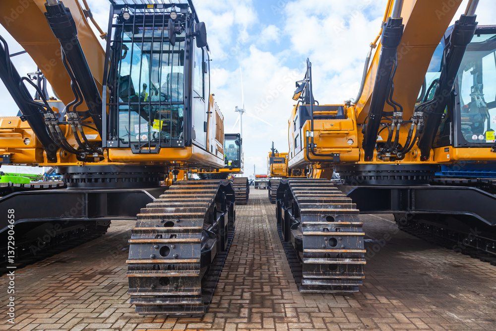 New yellow crawler excavators are parked on the site. New yellow crawler excavators are parked on the site.