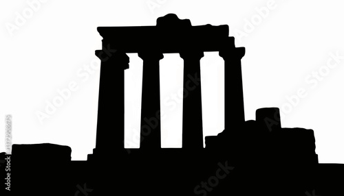 Historic temple ruins stand silhouetted against a pale background at sunset highlighting ancient architecture