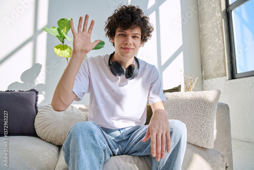 Young guy university student talking looking in web camera, at home