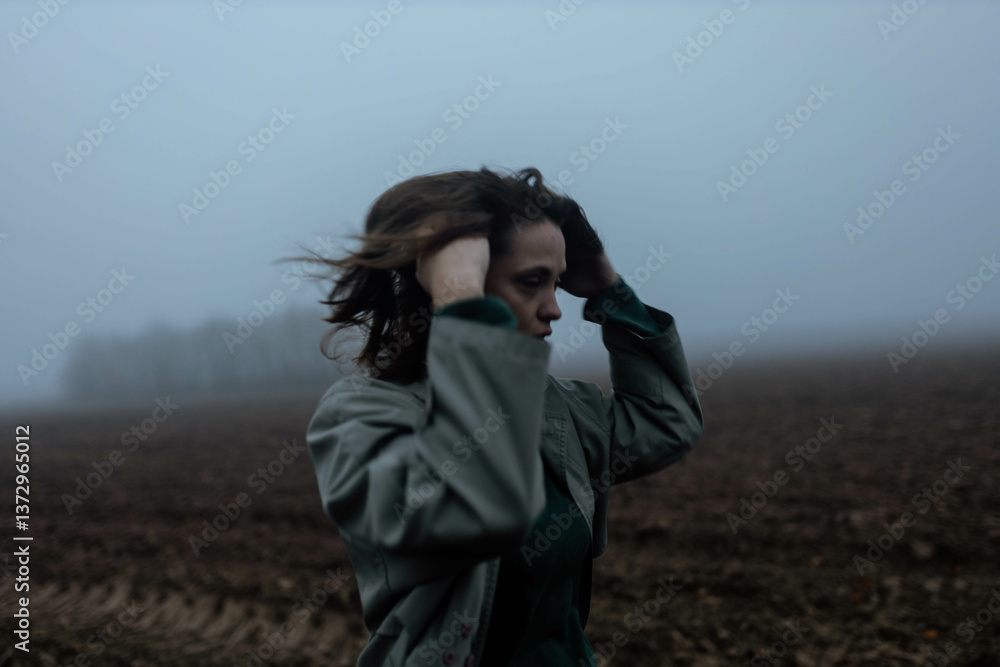 depressed woman in foggy field lonely and sad,