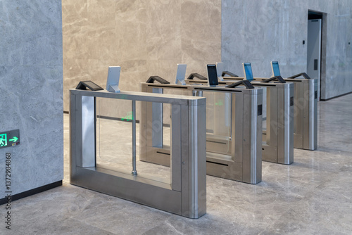 turnstile with access control system in modern office building interior.