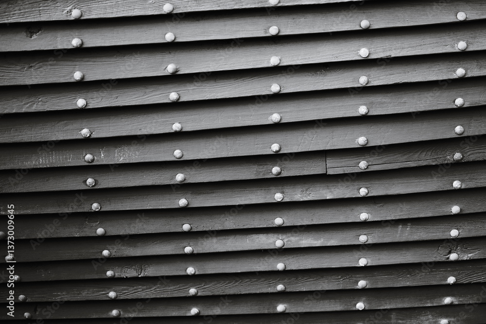 Obraz premium A close-up shot of a worn wooden wall with a distressed finish.