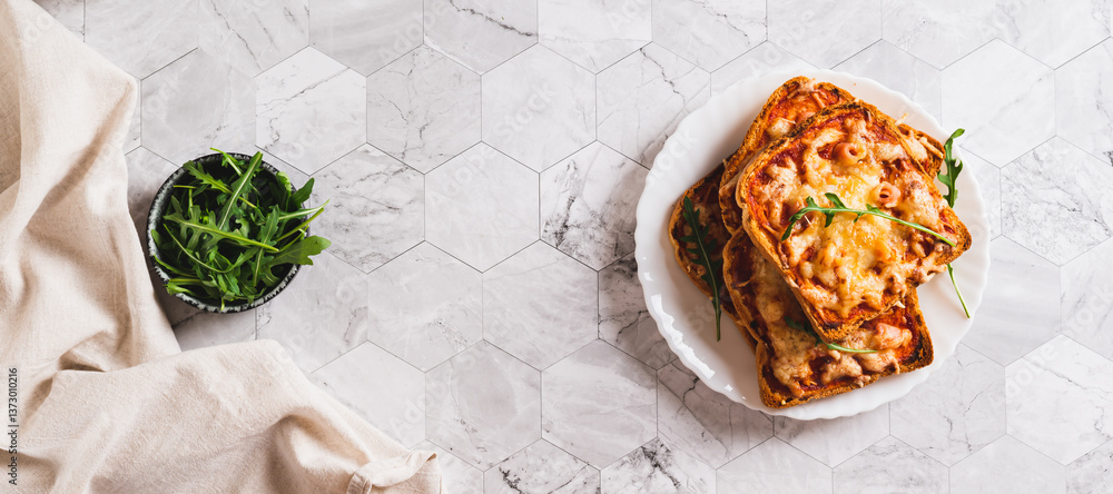 Crispy pizza with bacon, cheese and ketchup on toast on a plate top view web banner