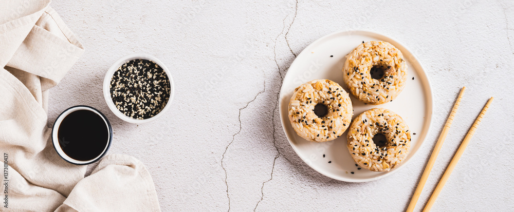 Rice donuts with meat and sesame seeds on a plate on the table top view web banner