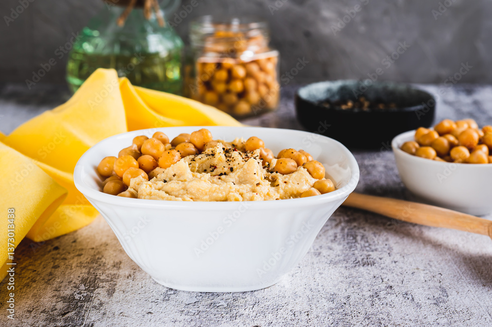 Homemade hummus with chickpeas in a bowl on the table