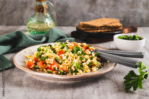 Obraz na płótnie Tabbouleh salad with bulgur, tomato and parsley on a plate on the table w salonie