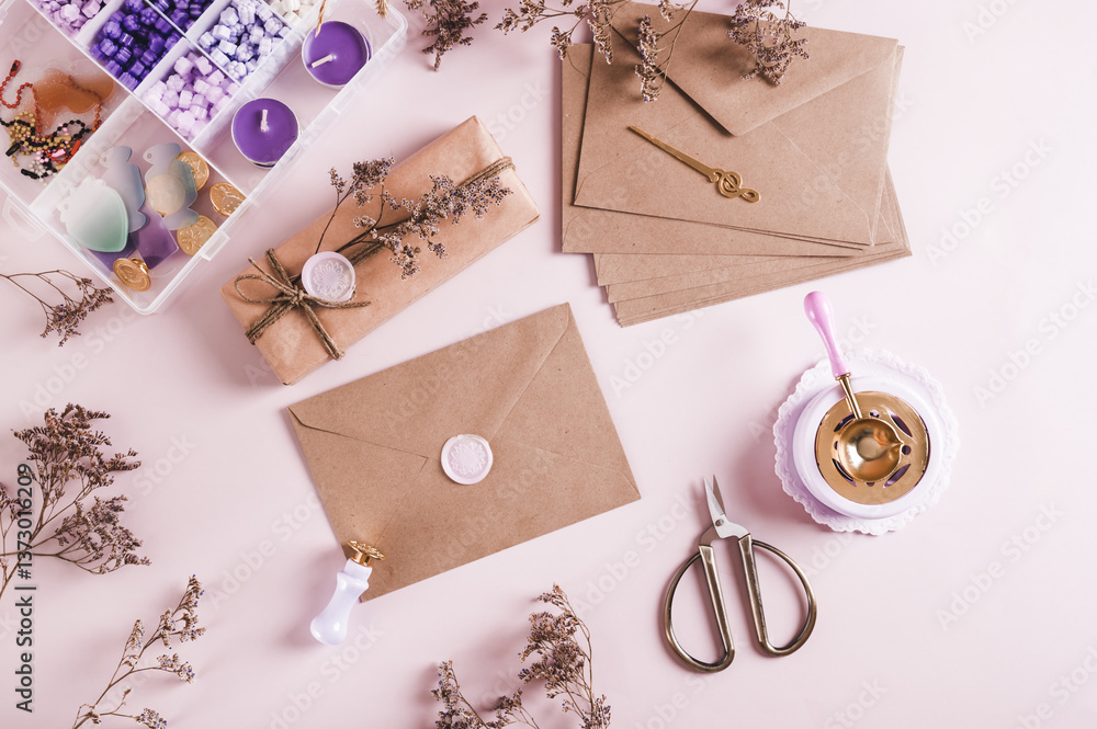 An envelope sealed with wax and a craft kit on the table top view