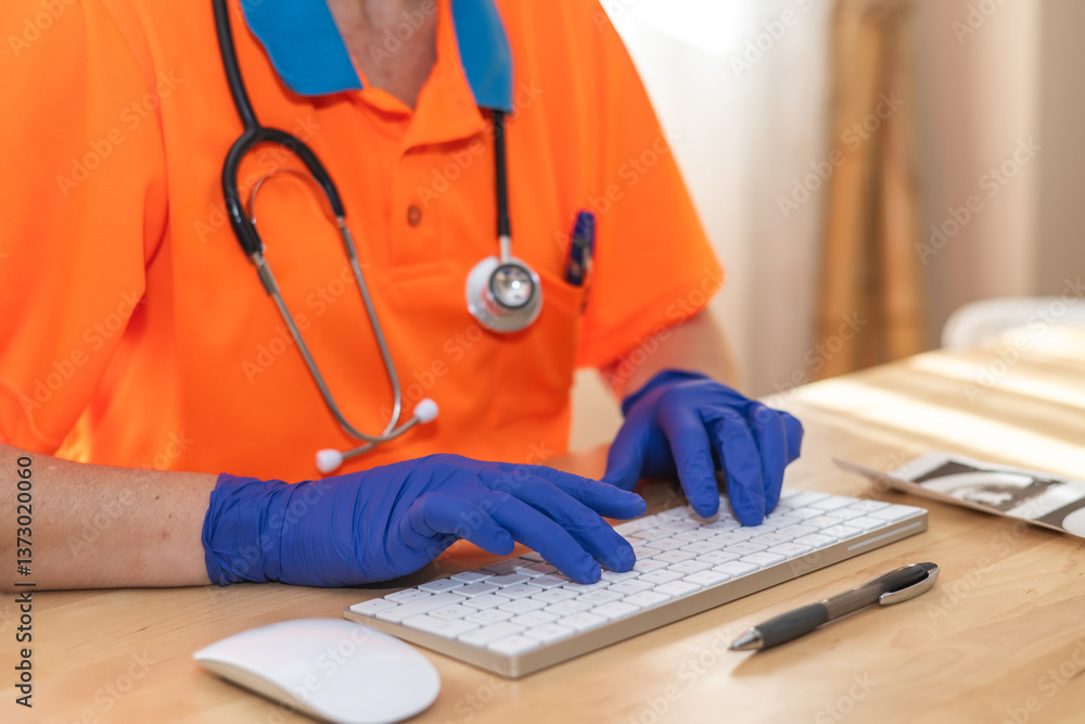 Paramedic with stethoscope around neck and wearing blue nitrile gloves typing medical report on white computer keyboard with mouse and pen on wooden table Paramedic with stethoscope around neck and wearing blue nitrile gloves typing medical report on white computer keyboard with mouse and pen on wooden table