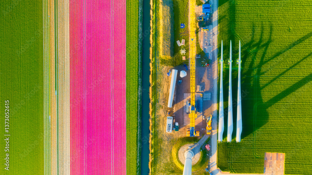 Construction and installation of a wind turbine. Production of clean green energy. Technology and innovation. Aerial view. Industrial landscape from a drone. Top view.