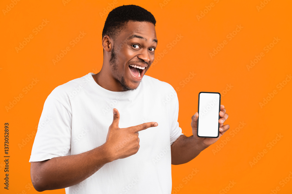 African American Guy Showing Smartphone Empty Screen Recommending Mobile Application Smiling To Camera Over Yellow Studio Background. Mockup African American Guy Showing Smartphone Empty Screen Recommending Mobile Application Smiling To Camera Over Yellow Studio Background. Mockup