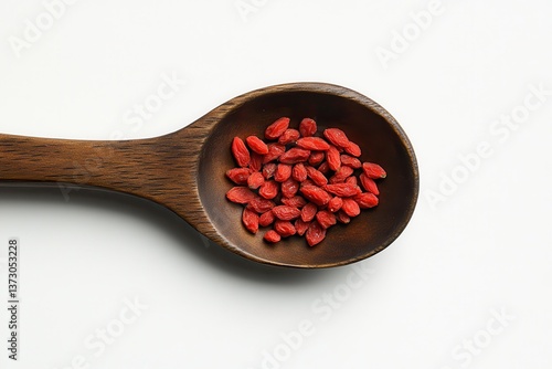 Aerial perspective of a wooden spoon filled with goji berries