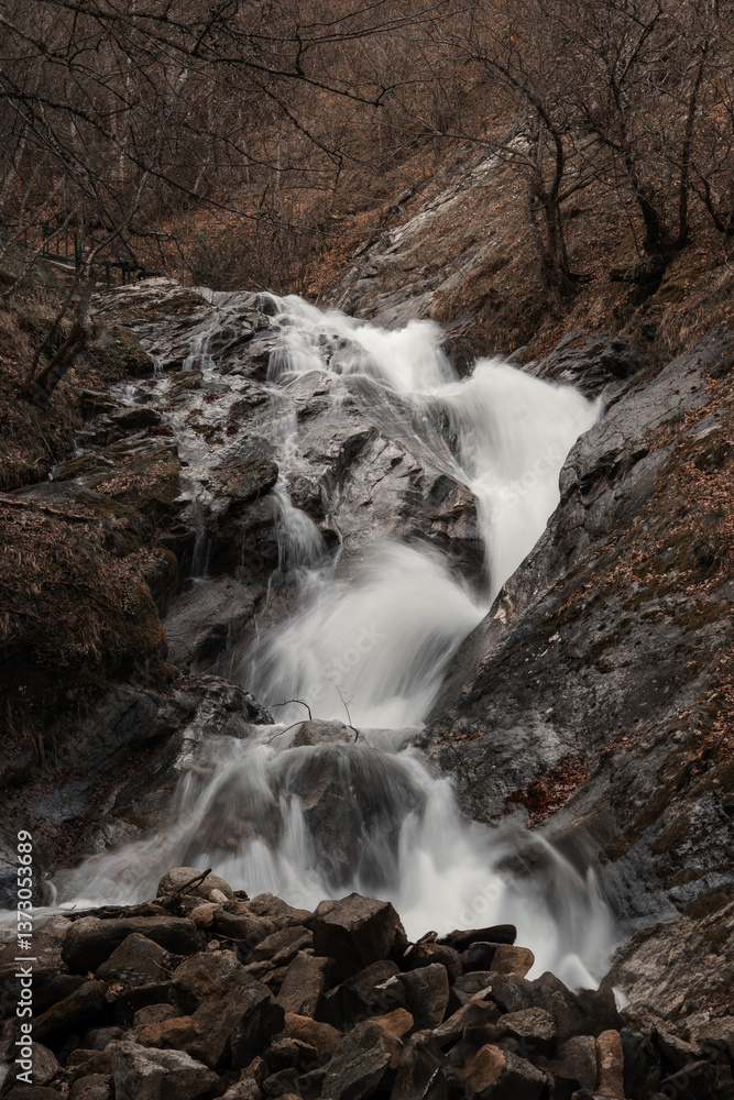 Fototapeta premium Small waterfall in a woodland setting