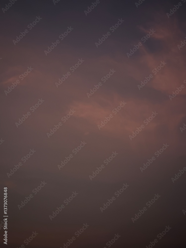 Dusky sky with soft clouds, painted with shades of purple and orange Dusky sky with soft clouds, painted with shades of purple and orange