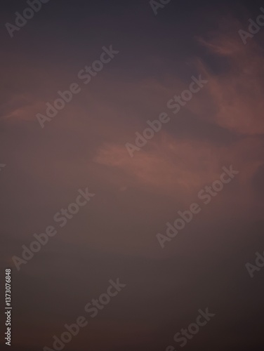 Dusky sky with soft clouds, painted with shades of purple and orange