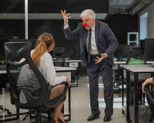 Fotografie Elderly Caucasian man wearing a clown nose swears at his subordinate in the office