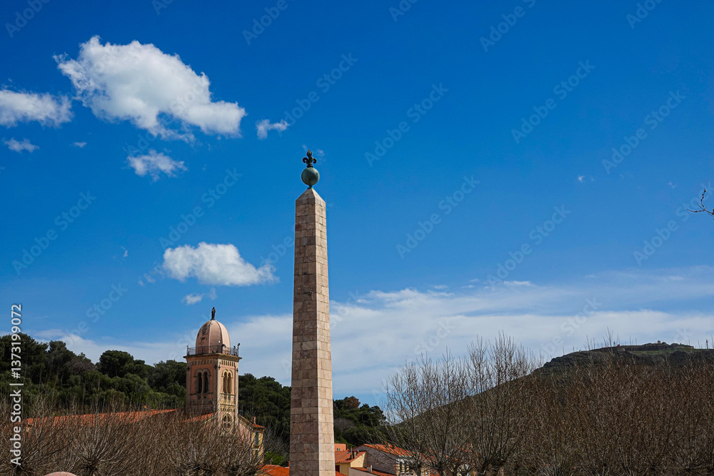 obelisk and roof of church of historic site. Port-Vendres, Occitanie, France
