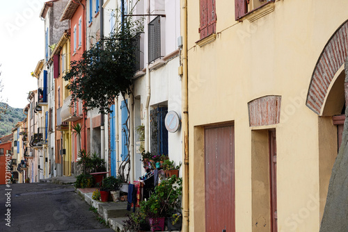 Obraz na płótnie Vibrant houses in a small village create an inviting scene along a narrow street.Port-Vendres, Occitanie, France w salonie