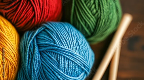 Obraz na płótnie Colorful yarn balls and knitting needles arranged on a wooden table for crafting and creativity w salonie