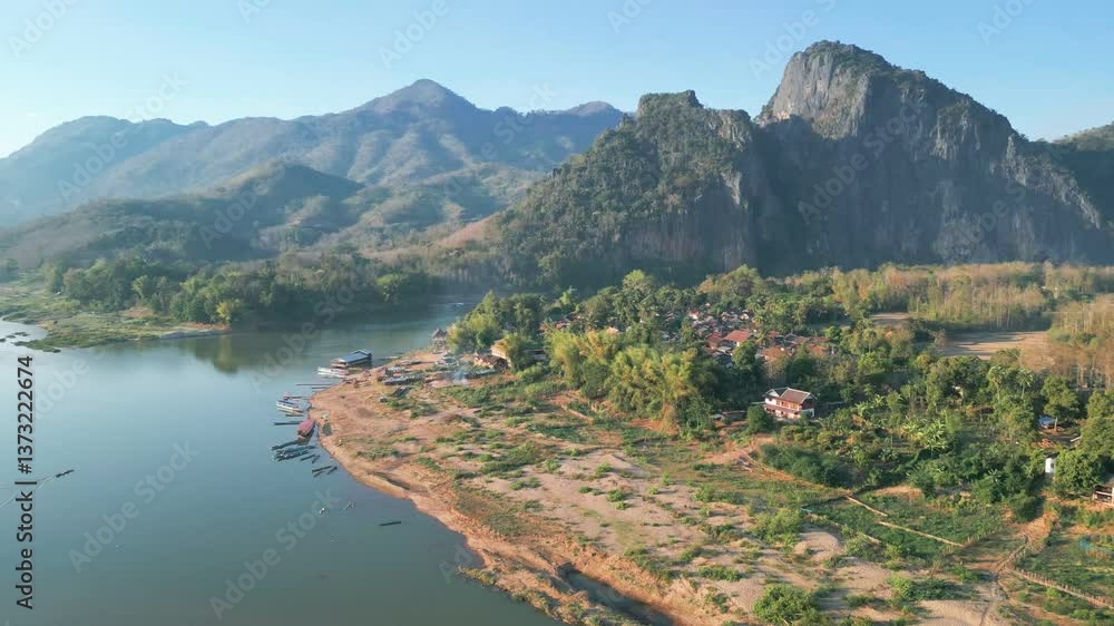 Aerial video shows a river through a scenic Laos landscape with mountains Aerial video shows a river through a scenic Laos landscape with mountains